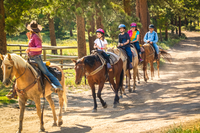group of people riding horses