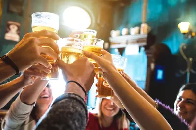 people cheersing with beers
